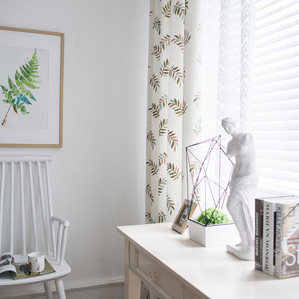 Melodieux white curtain with green leaves pattern in a sunlit room